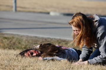Crying in sadness, junior Kylee Reichman participates in the mock wreck. 