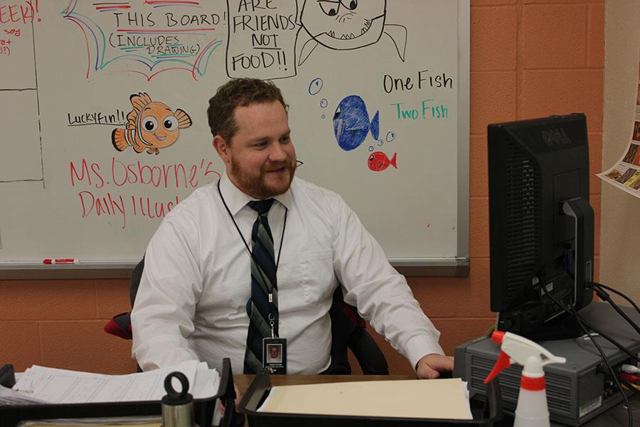 Working at his computer, new science teacher Daniel Strang enjoys his teaching job at Ray-Pec more so than his past ones. 