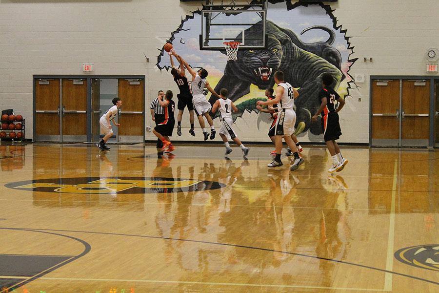 The varsity boys play against Platte County on Nov. 20 at the Basketball Jamboree. The team won games against all three teams, the other two being Laffayette County and Park Hill