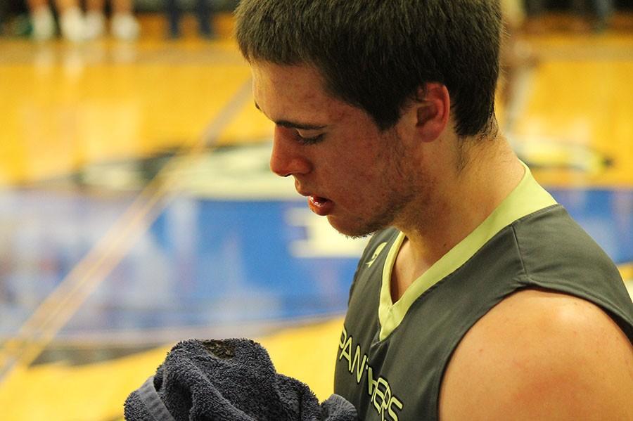 Sappington wipes his bleeding nose after being elbowed in the face by a Rockhurst player.