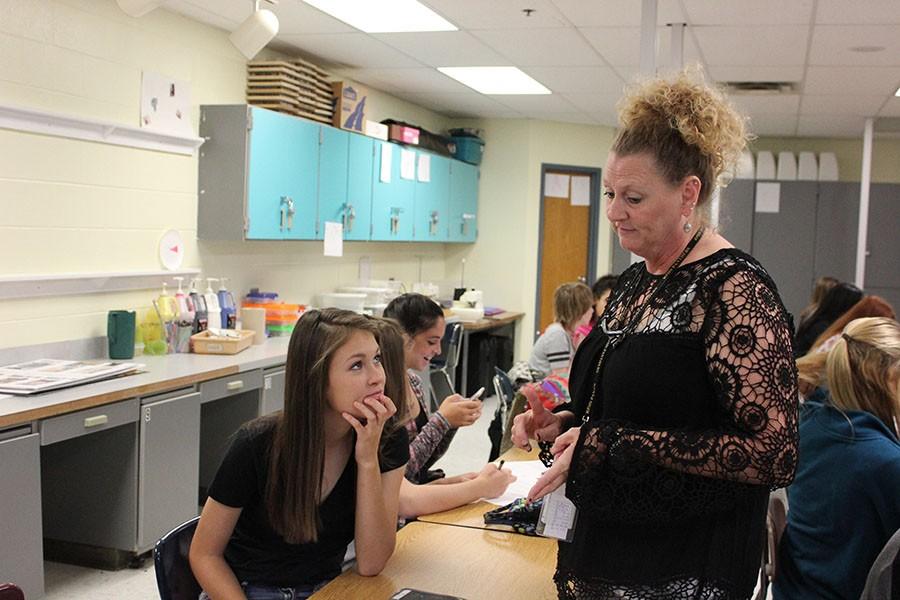 FACS. Teaching her students, Mrs. Snyder shows students Emma Newman what to do on her project.  