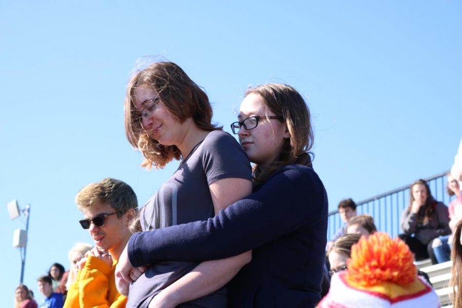 Support. Sophomore Avigail Kuntz aids her freshman sister Katie Kuntz by hugging her after Katie stood up in the middle of the protest and spoke out. “She told me it was idiotic but she was proud of me,” said Katie Kuntz