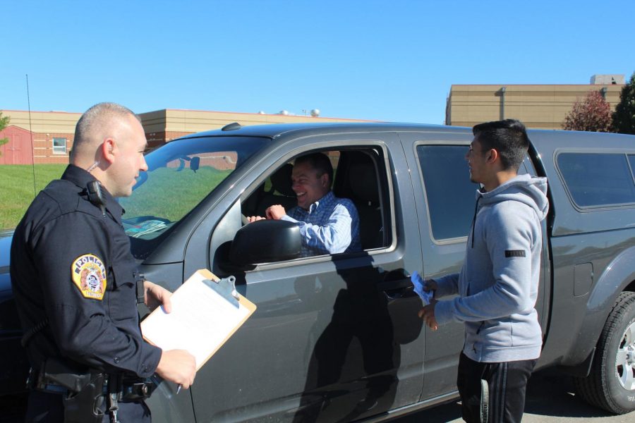 Pulled over. Running through cop protocol, senior Brandon Rayos gives teacher Doug Brown a speeding ticket. Officer Clausing conducts the test for Rayos during the activity. 