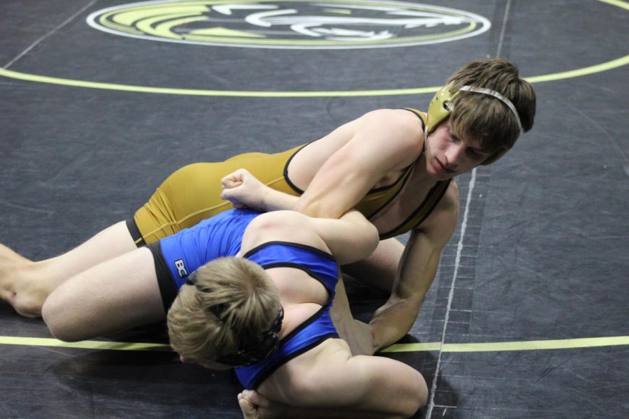 PINNED.+Grabbing+his+arms%2C+Sophomore+Patrick+Martin+tries+to+pin+a+team+member+from+Rockhurst+to+the+mat.+This+was+Martin%E2%80%99s+first+night+back+at+wrestling+from+his+elbow+injury.