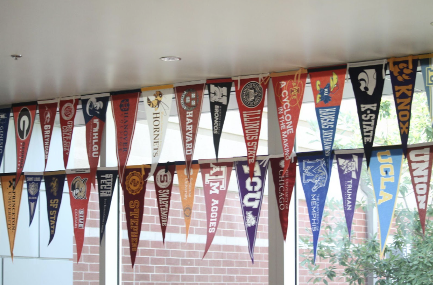 College flags from a variety of universities hang outside the College and Career Office.